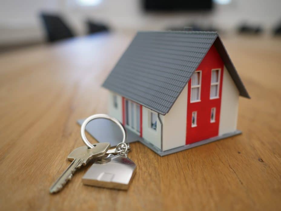image of house keys and a small model of a house 